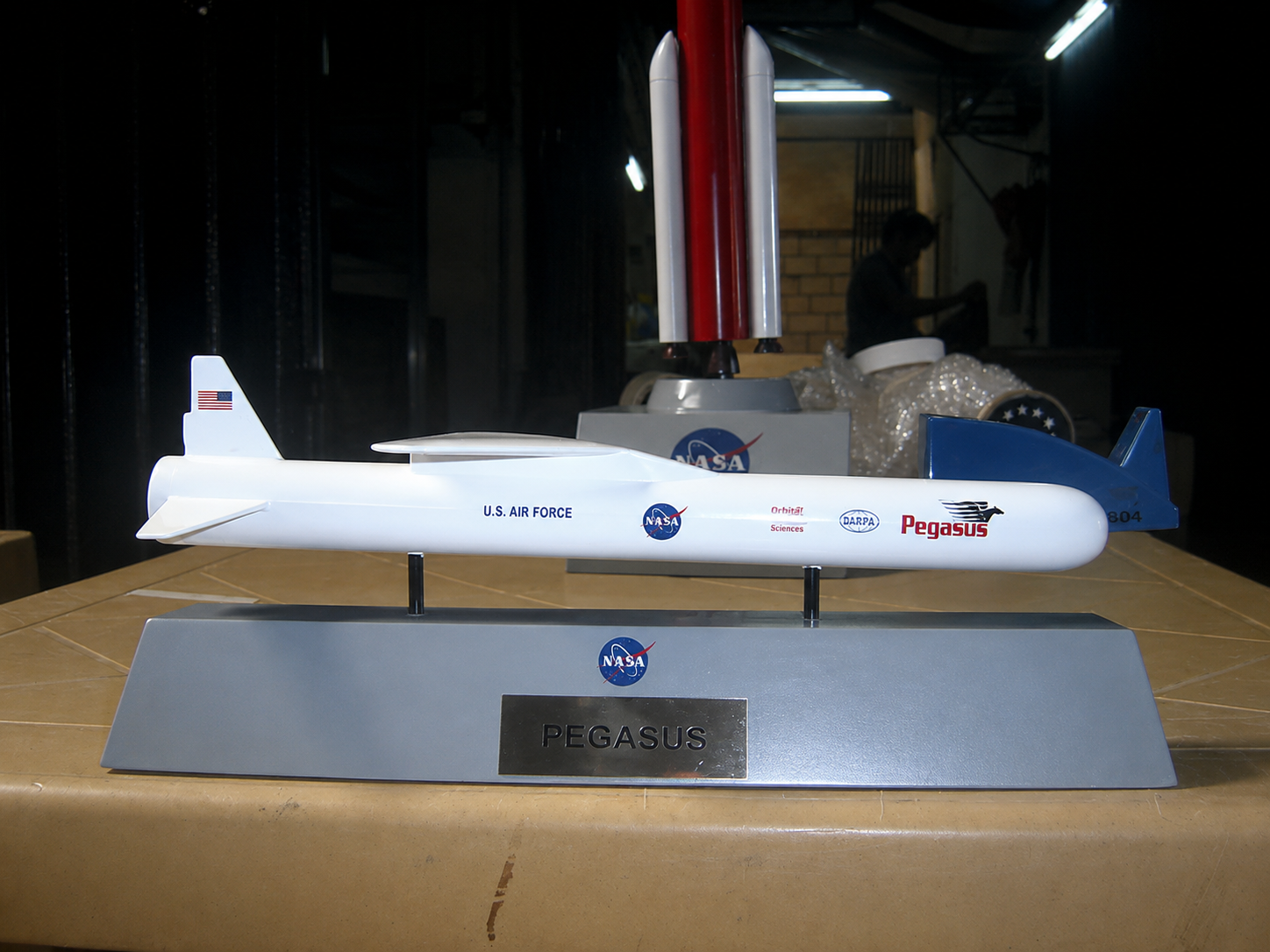 Four-foot NASA Pegasus rocket model with U.S. Air Force, DARPA, and Orbital Sciences markings on a display base at the National Museum of the U.S. Air Force